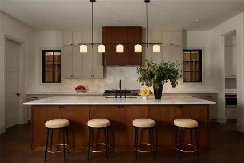 a bedroom with a bed couch and large window