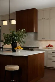 a bathroom with a granite countertop sink a large mirror and a potted plant