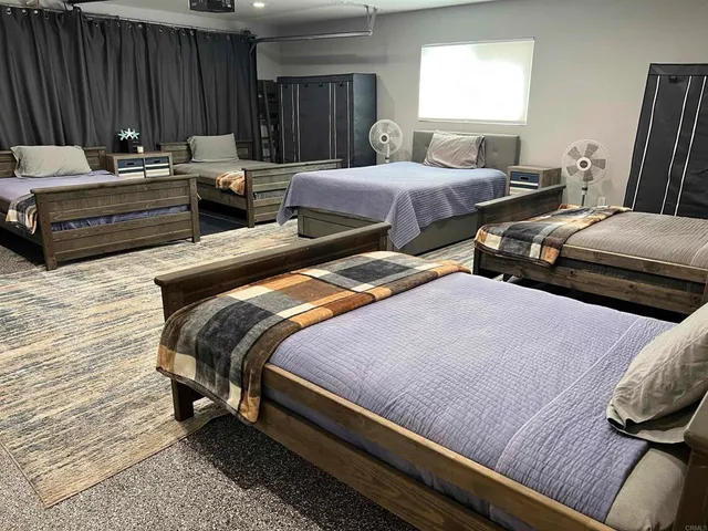 a bedroom with two beds and a couch