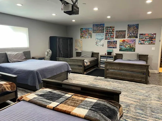 a large bed sitting in a bedroom next to a window