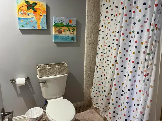 a spacious bathroom with a granite countertop sink and a mirror