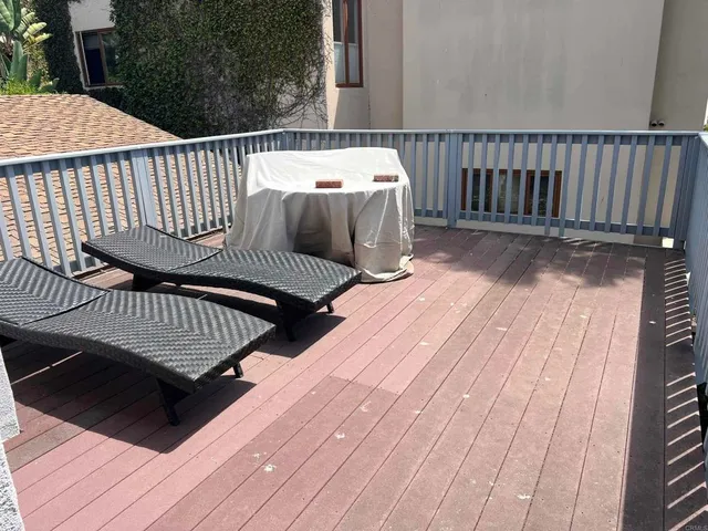 a kitchen with a sink a refrigerator and cabinets
