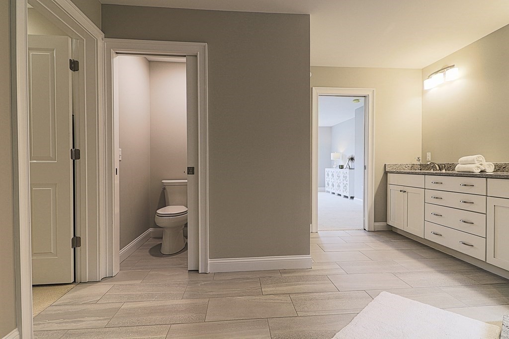 38 F Hiley Brook Road Stow, MA 01775 - Photo 15 of 26 a spacious bathroom with a toilet sink and a mirror
