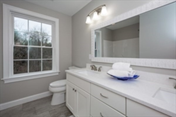 38 F Hiley Brook Road Stow, MA 01775 - Photo 24 of 26 a bathroom with a toilet sink mirror and window
