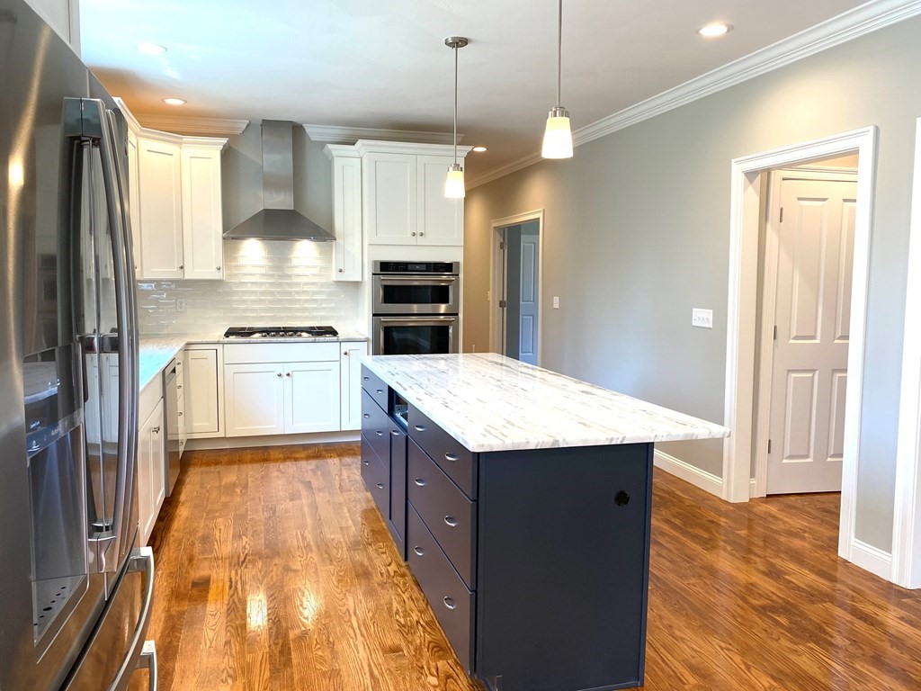 38 F Hiley Brook Road Stow, MA 01775 - Photo 26 of 26 a kitchen with kitchen island a counter top space appliances and cabinets