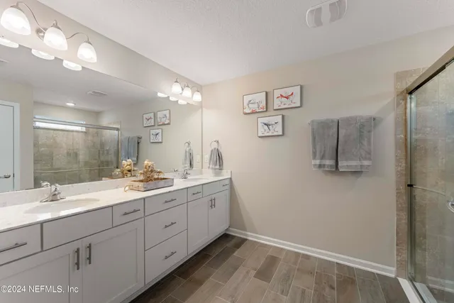 a bathroom with a double vanity sink and mirror