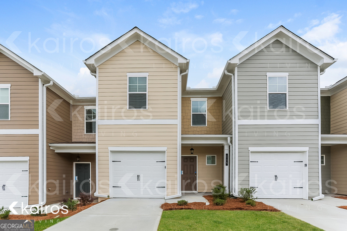 115 Dudley Way Southwest Cartersville, GA 30120 - Photo 1 of 16 a front view of a house with a yard and garage