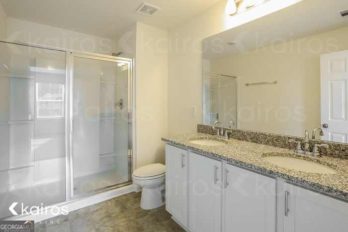 115 Dudley Way Southwest Cartersville, GA 30120 - Photo 12 of 16 a bathroom with a granite countertop sink toilet and shower