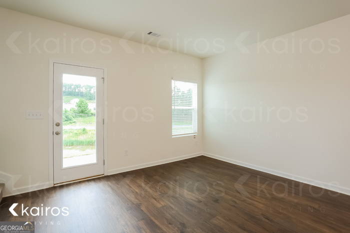 115 Dudley Way Southwest Cartersville, GA 30120 - Photo 3 of 16 an empty room with wooden floor and windows
