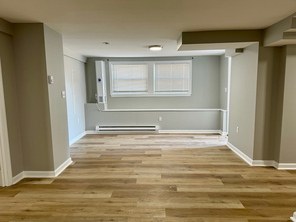 38 Emmons Street, Unit 5 Franklin, MA 02038 - Photo 11 of 16 a view of empty room with wooden floor and fan