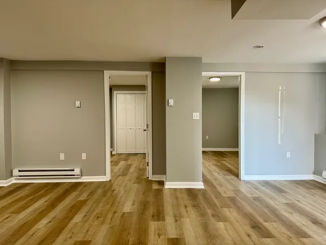 a view of a room with wooden floor and bathroom