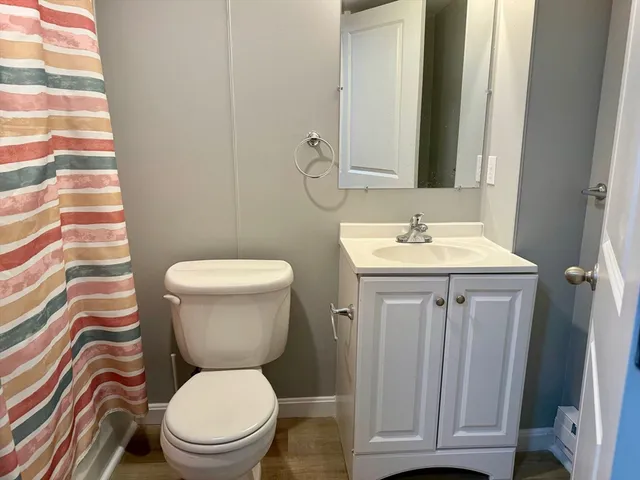 a bathroom with a toilet a sink and a mirror