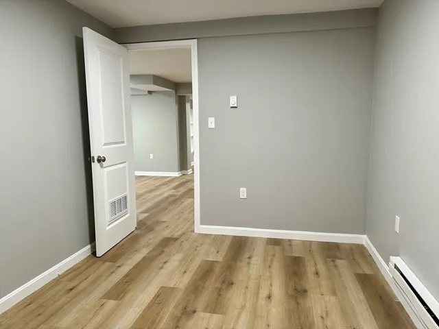 a view of walk in closet with wooden floor
