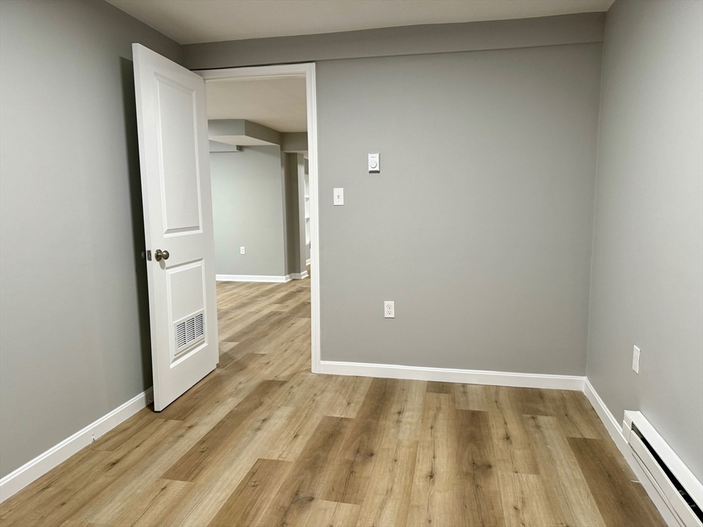 38 Emmons Street, Unit 5 Franklin, MA 02038 - Photo 7 of 16 a view of walk in closet with wooden floor