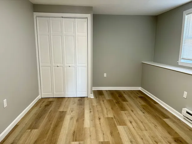 a view of a room with wooden floor and bathroom