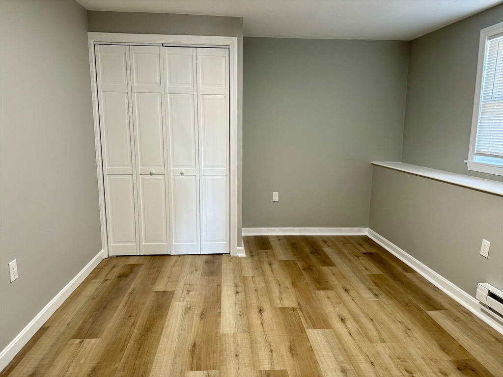 38 Emmons Street, Unit 5 Franklin, MA 02038 - Photo 8 of 16 a view of a room with wooden floor and bathroom