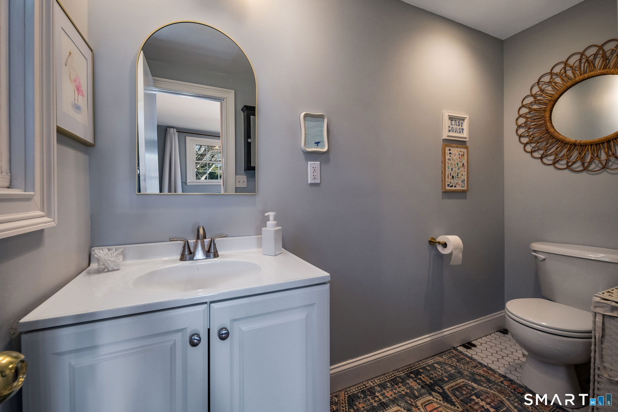 99 Maple Avenue Old Saybrook, CT 06475 - Photo 13 of 30 a bathroom with a toilet sink vanity and mirror