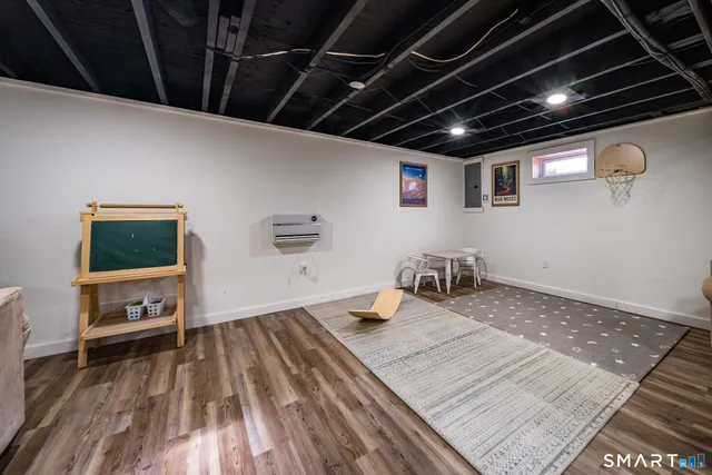 a kitchen with a stove and wooden floor