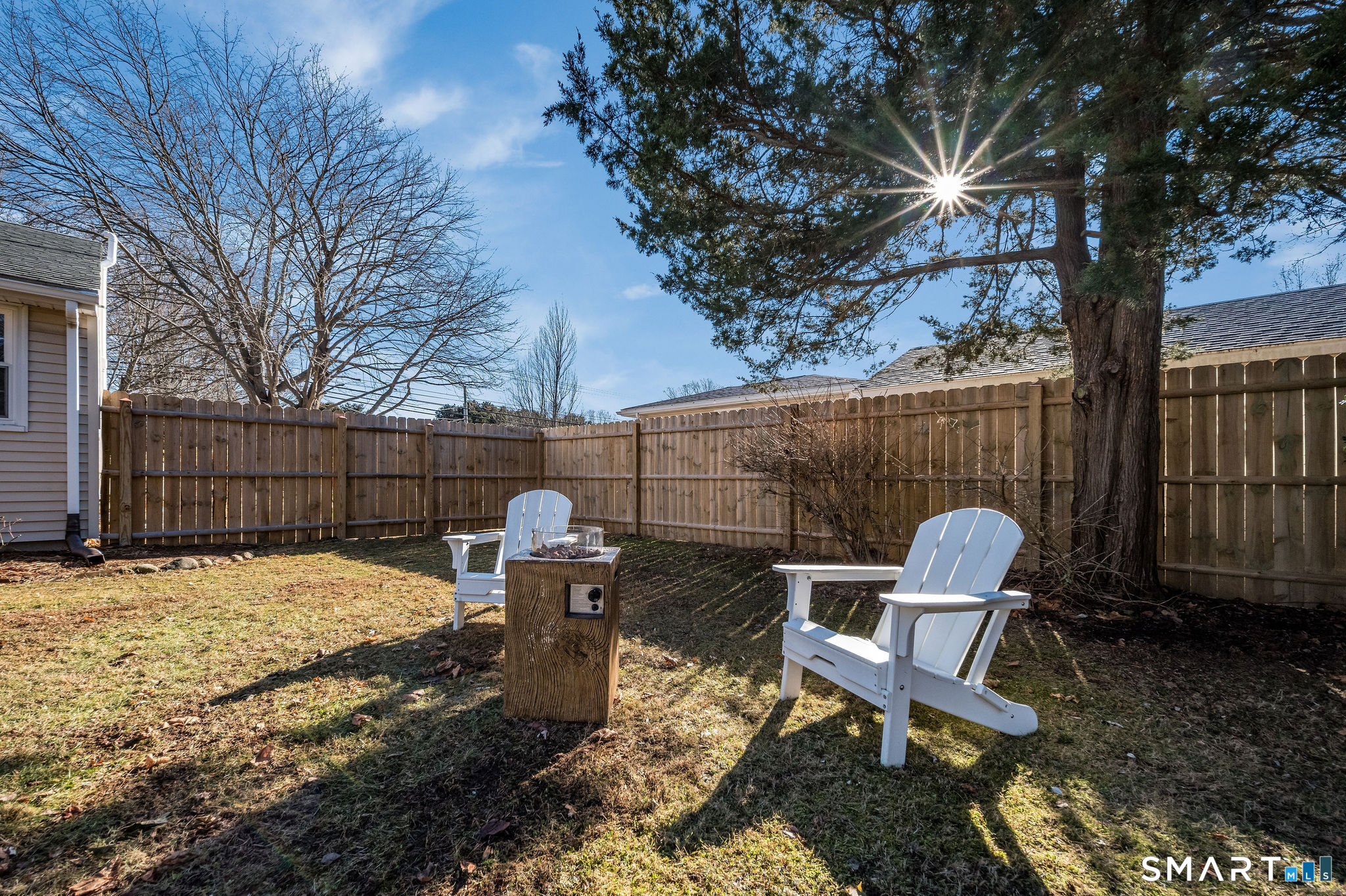 99 Maple Avenue Old Saybrook, CT 06475 - Photo 26 of 30 a view of a backyard with chairs and a fire pit