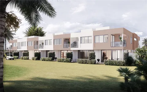 a view of multiple houses with palm trees