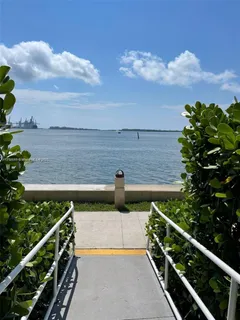 a view of yard from deck with patio