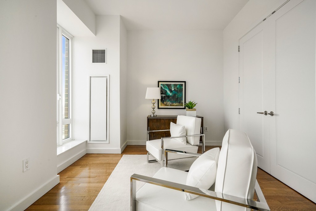 400 Stuart Street, Unit 29C Boston, MA 02116 - Photo 6 of 16 a living room with furniture and a wooden floor