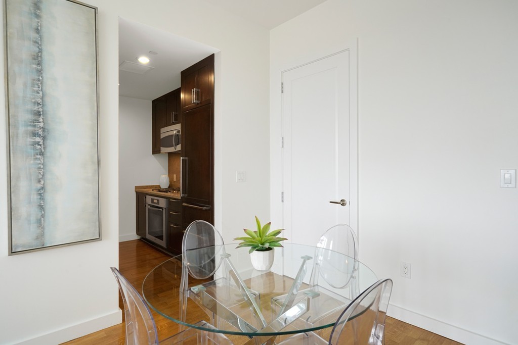 400 Stuart Street, Unit 29C Boston, MA 02116 - Photo 8 of 16 a dining room with furniture and wooden floor