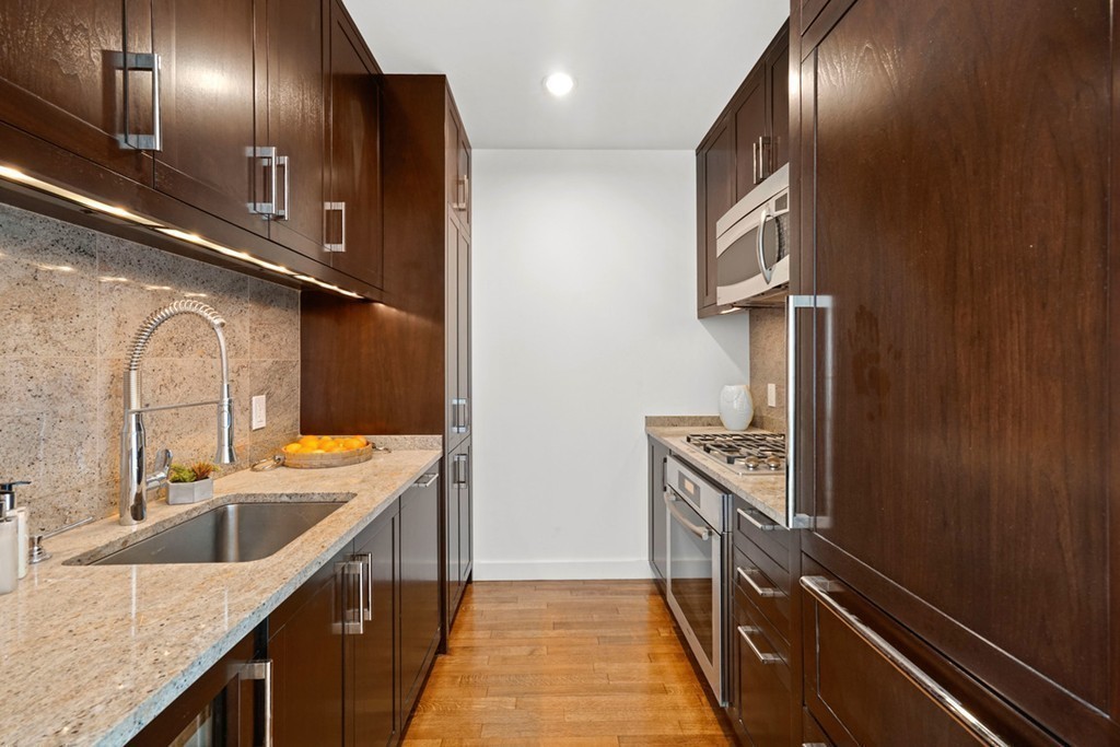 400 Stuart Street, Unit 29C Boston, MA 02116 - Photo 9 of 16 a kitchen with stainless steel appliances granite countertop a sink and stove