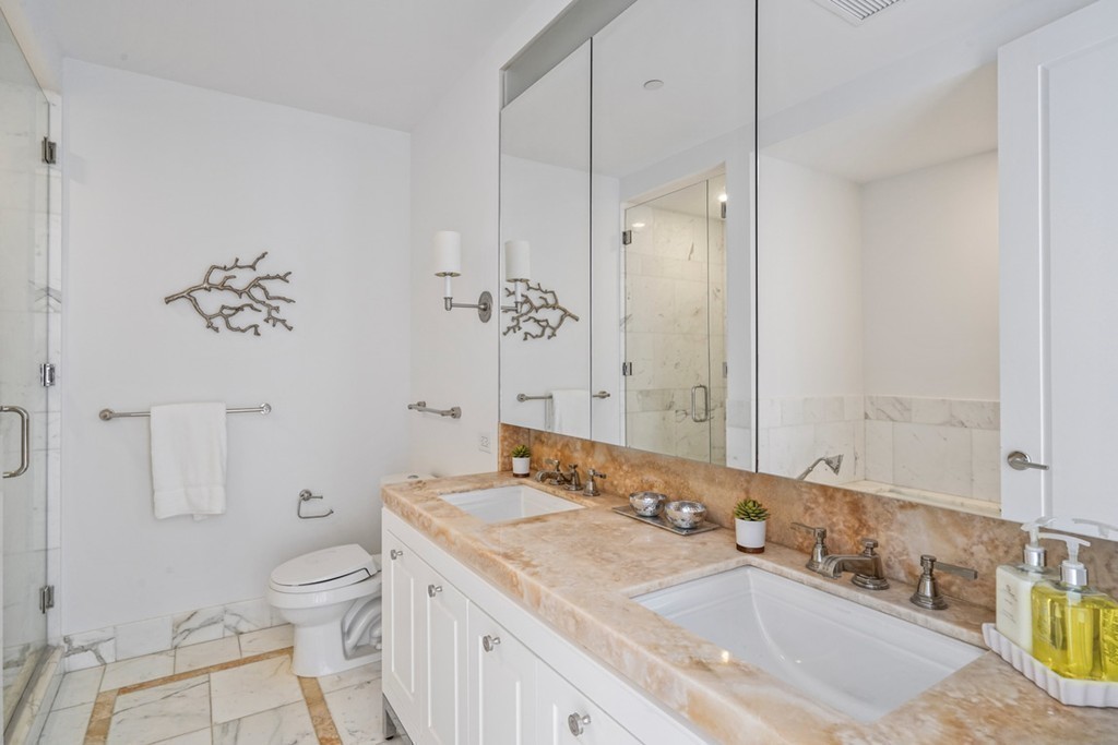 400 Stuart Street, Unit 29C Boston, MA 02116 - Photo 10 of 16 a bathroom with a granite countertop sink a toilet and a bathtub
