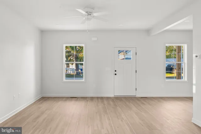 wooden floor in an empty room with a window