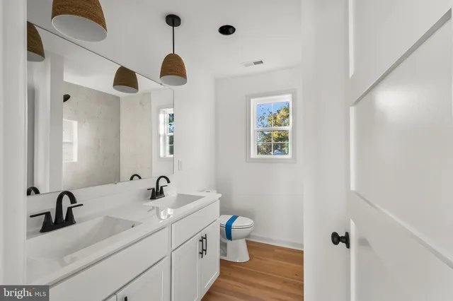 a bathroom with a double vanity sink and a mirror