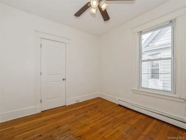 wooden floor in an empty room with a window