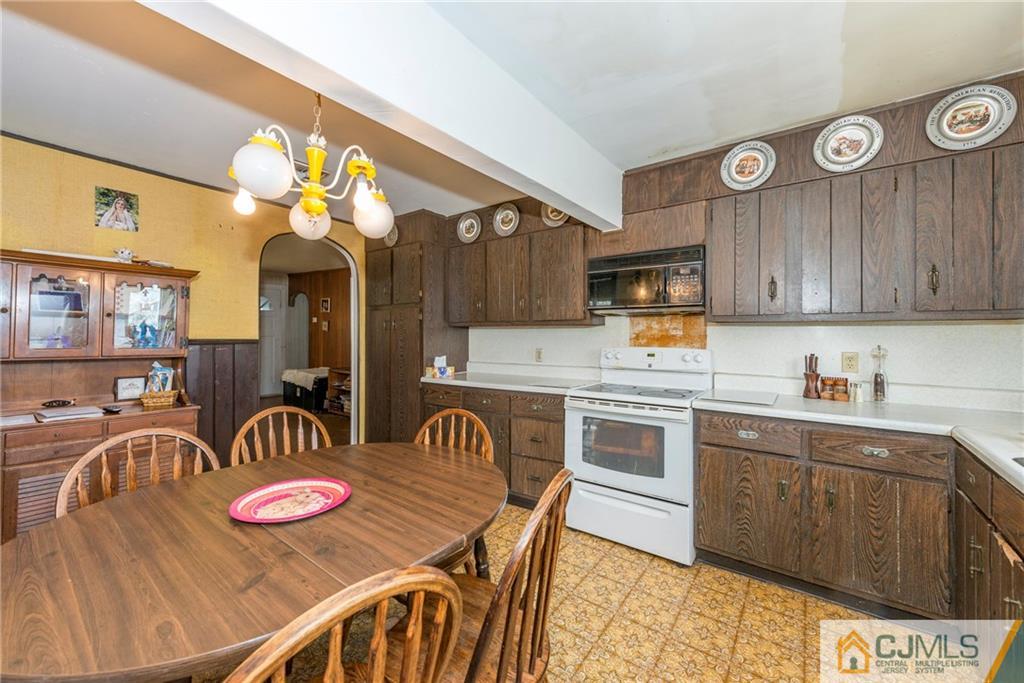 65 Ford Road Howell, NJ 07731 - Photo 11 of 22 a kitchen with stainless steel appliances granite countertop a stove top oven a sink dishwasher and cabinets with wooden floor