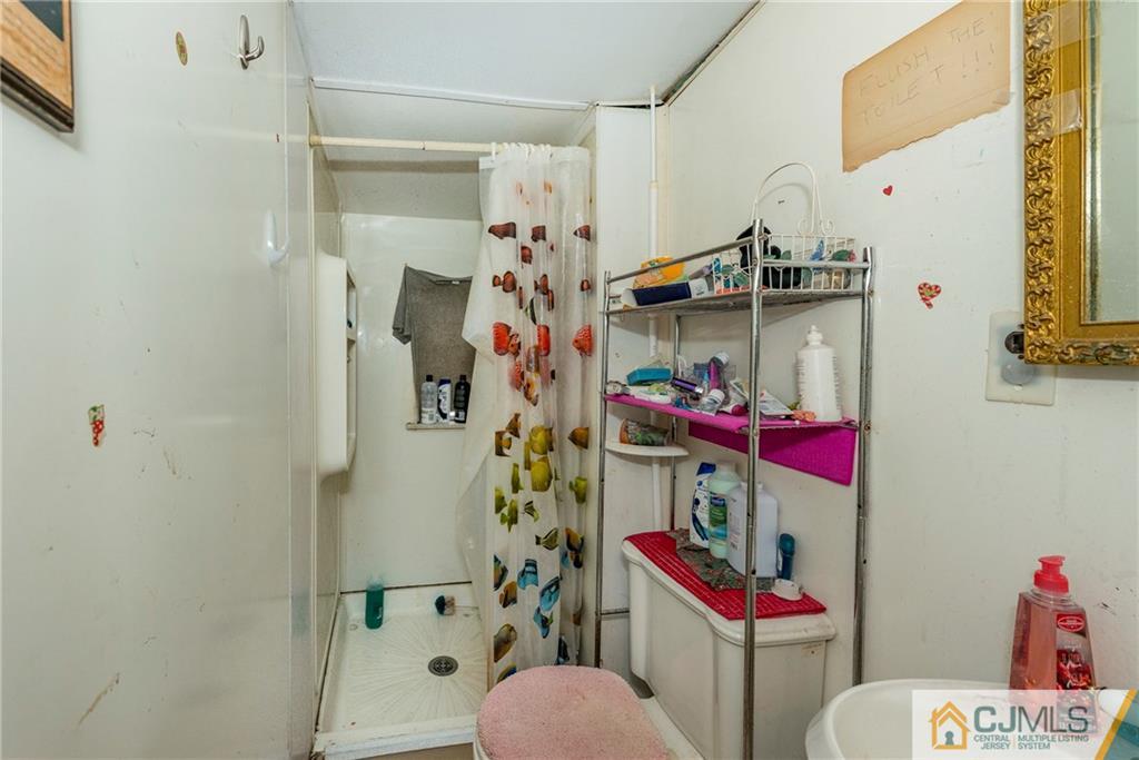 65 Ford Road Howell, NJ 07731 - Photo 19 of 22 a bathroom with a sink toilet and shower curtain