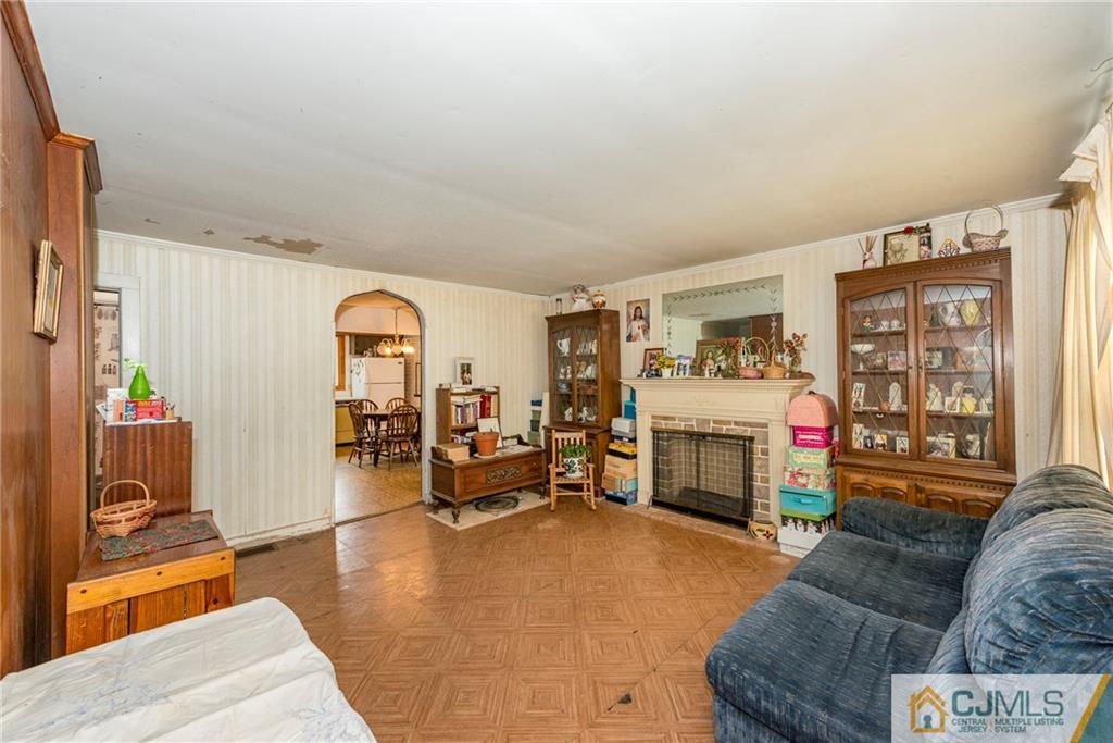 65 Ford Road Howell, NJ 07731 - Photo 7 of 22 a living room with furniture and a fireplace