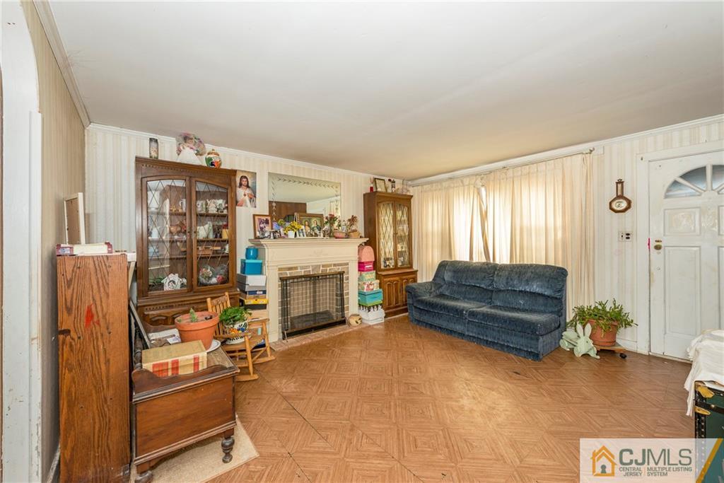 65 Ford Road Howell, NJ 07731 - Photo 8 of 22 a living room with furniture a flat screen tv and a fireplace