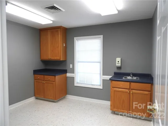 a kitchen with granite countertop cabinets and window