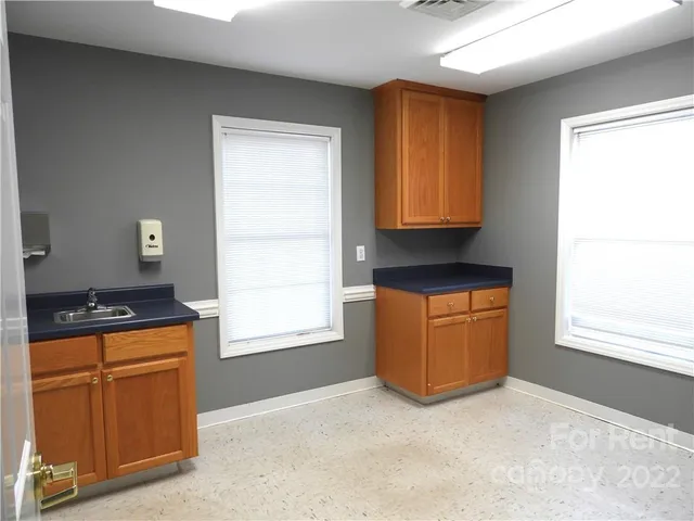 a kitchen with granite countertop cabinets and window