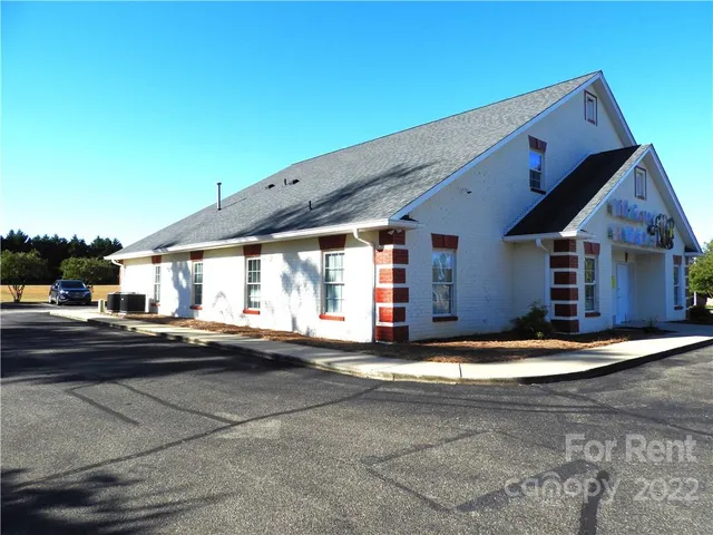 a view of a car park the front of house