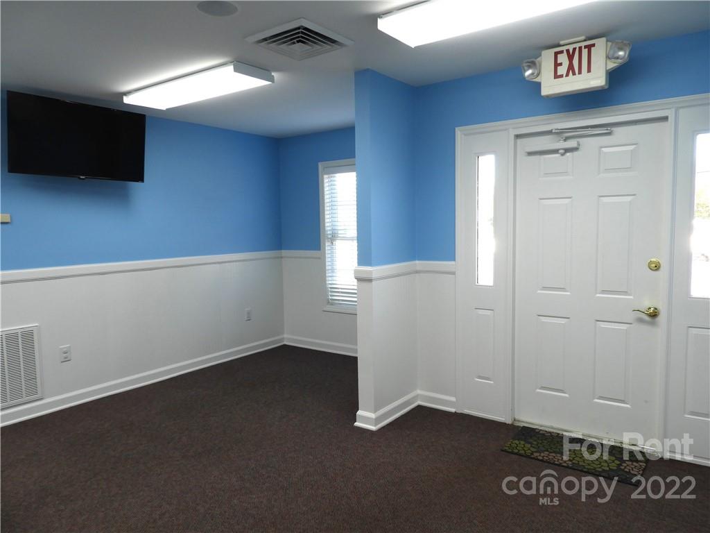 327 West College Avenue Boiling Springs, NC 28152 - Photo 5 of 24 an empty room with wooden floor and windows