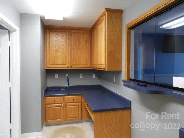 a kitchen with stainless steel appliances granite countertop wooden cabinets a stove and a sink