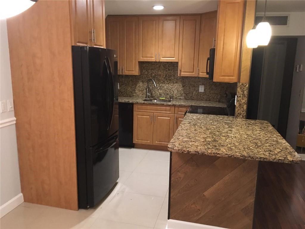 276 Monaco Way Delray Beach, FL 33446 - Photo 2 of 7 a kitchen with stainless steel appliances granite countertop cabinets and refrigerator
