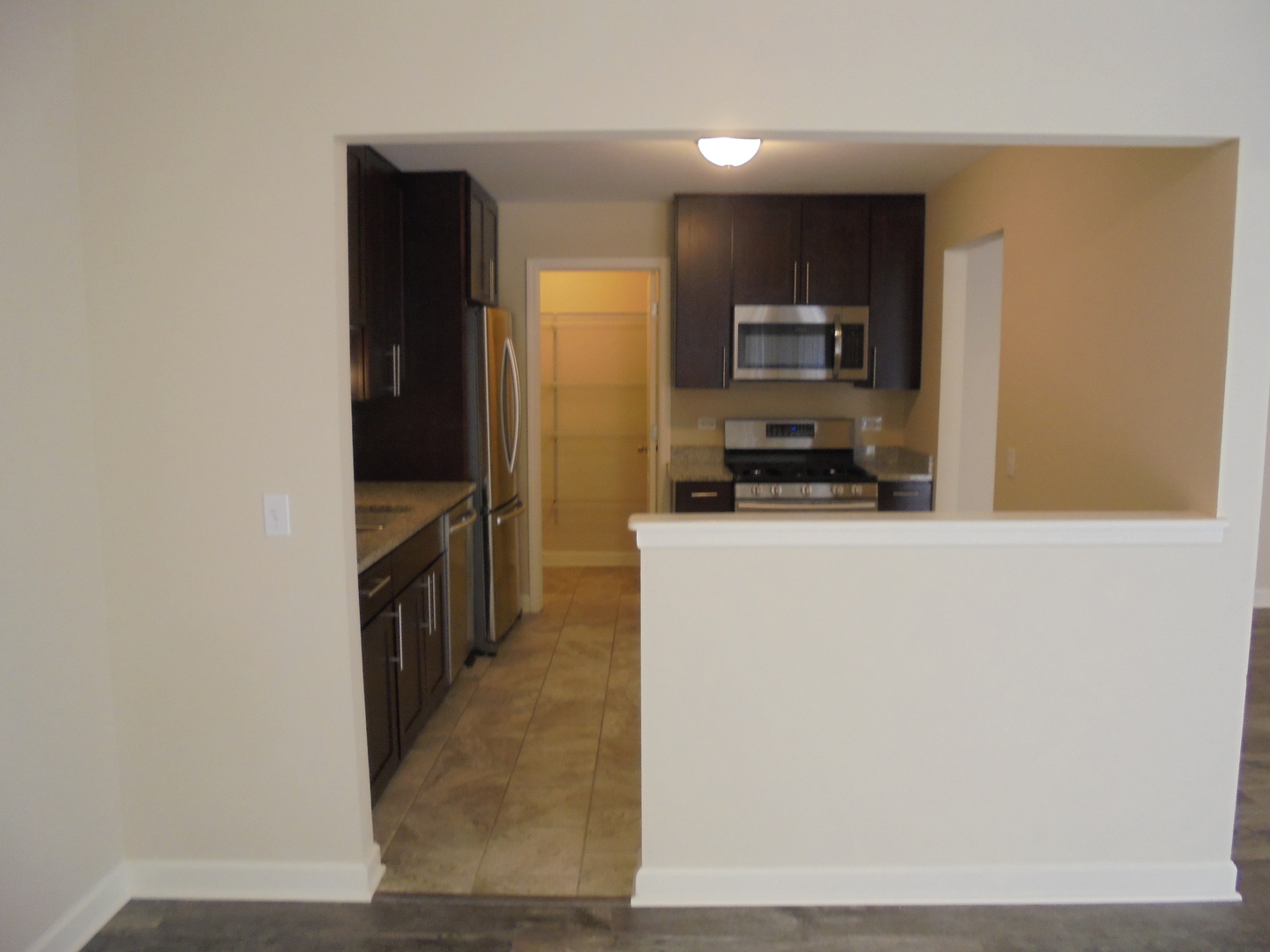 1534 Springview Court, Unit B2 Wheeling, IL 60090 - Photo 12 of 29 a kitchen view with microwave and refrigerator