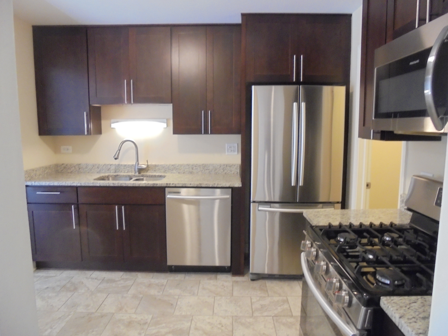 1534 Springview Court, Unit B2 Wheeling, IL 60090 - Photo 16 of 29 a kitchen with granite countertop a refrigerator stove and sink
