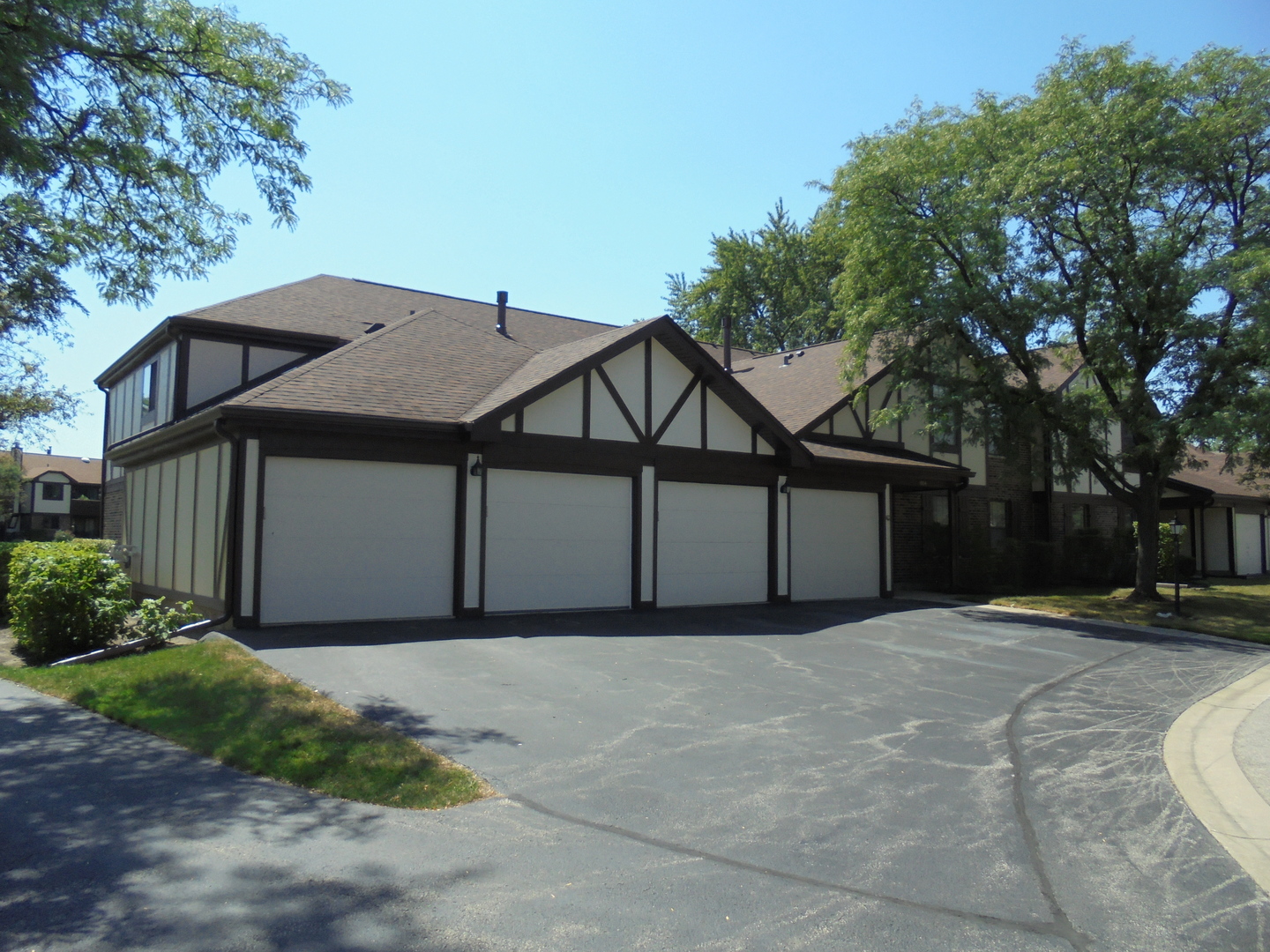 1534 Springview Court, Unit B2 Wheeling, IL 60090 - Photo 2 of 29 a front view of a house with a yard and garage