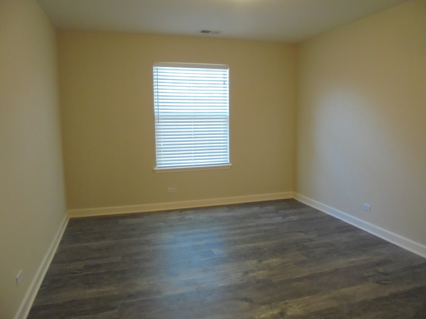1534 Springview Court, Unit B2 Wheeling, IL 60090 - Photo 24 of 29 an empty room with wooden floor and a window