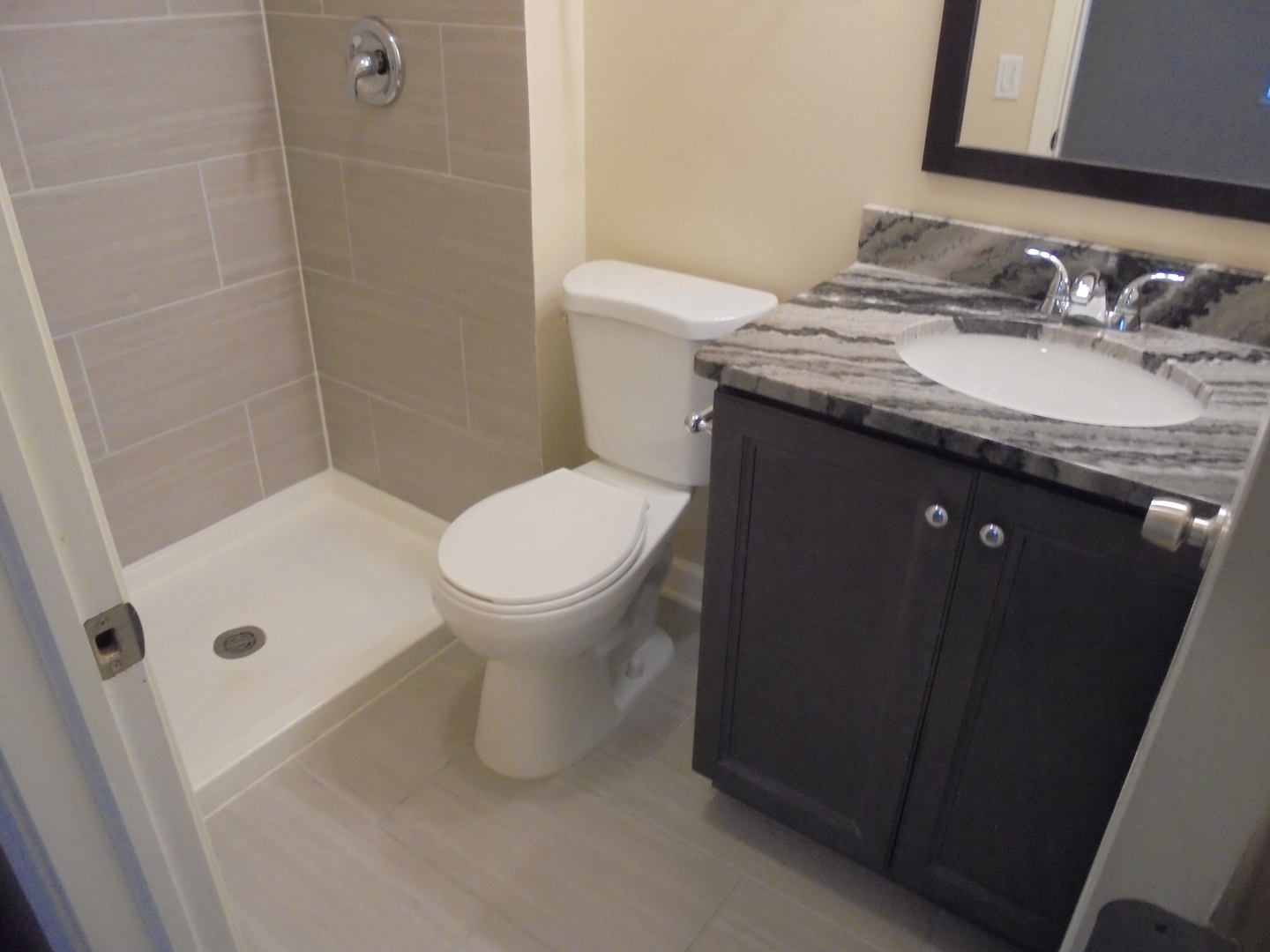 1534 Springview Court, Unit B2 Wheeling, IL 60090 - Photo 26 of 29 a bathroom with a granite countertop sink toilet and shower