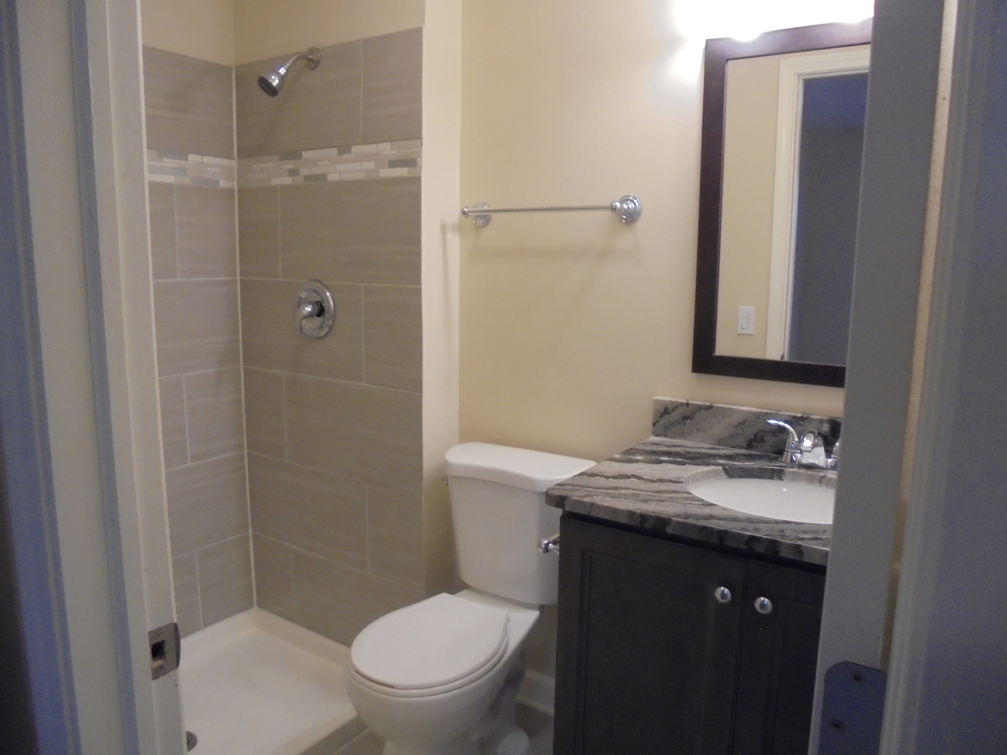 1534 Springview Court, Unit B2 Wheeling, IL 60090 - Photo 27 of 29 a bathroom with a granite countertop toilet sink and shower