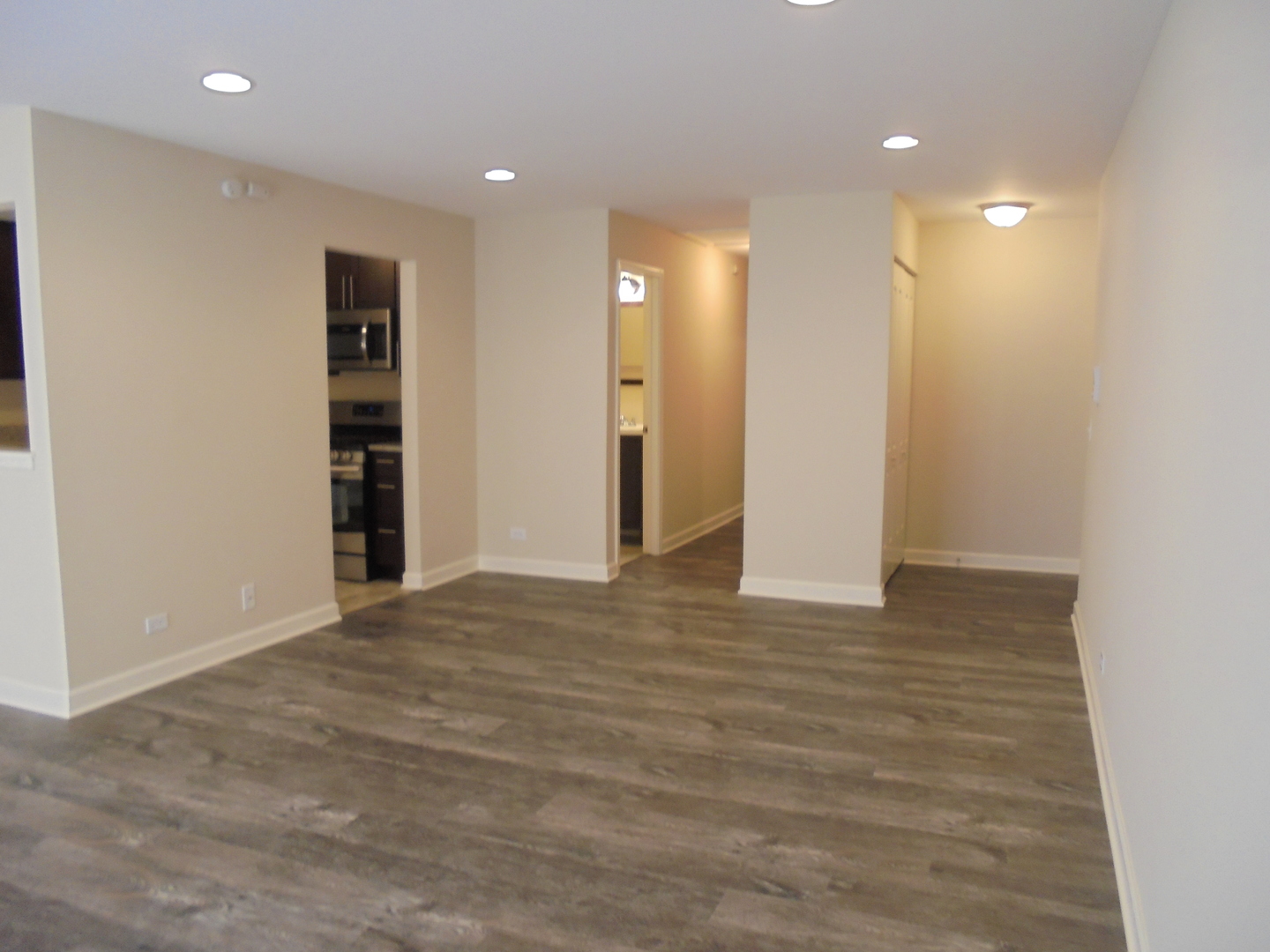 1534 Springview Court, Unit B2 Wheeling, IL 60090 - Photo 4 of 29 a view of an empty room with wooden floor and closet
