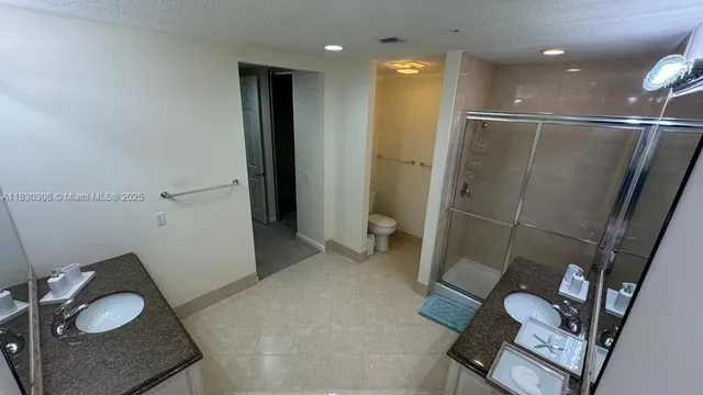 a bathroom with a sink toilet and shower